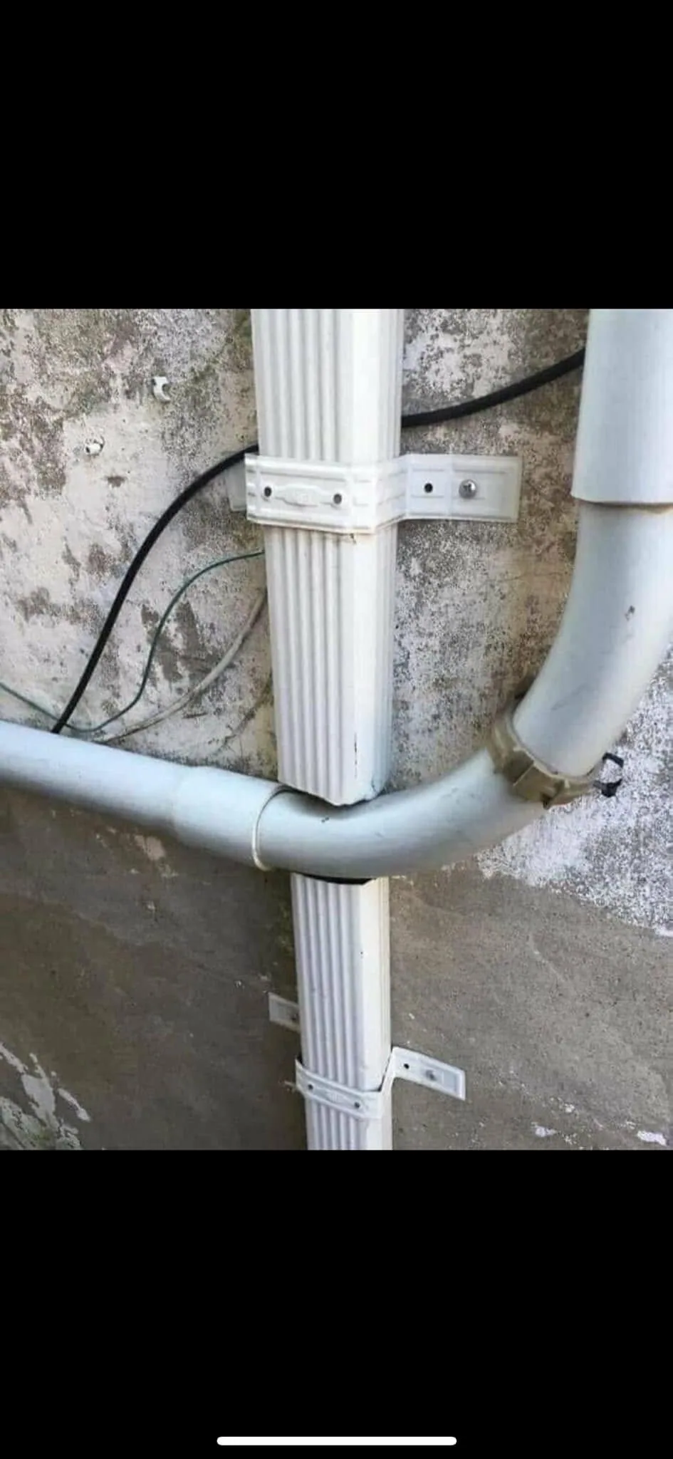 Downspout crushed by pvc drain pipe stucco wall