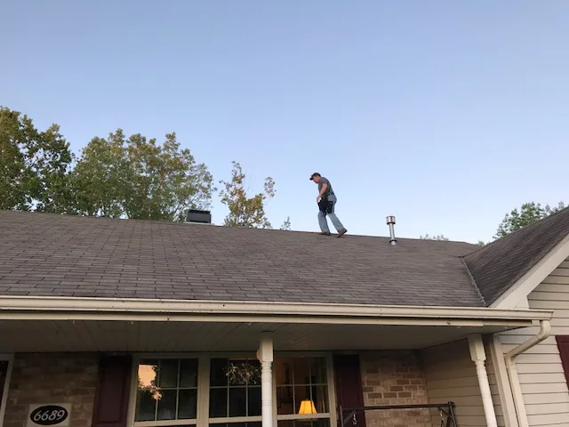 Home inspector walking roof