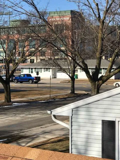 Lambeau field view residential street white ranch home