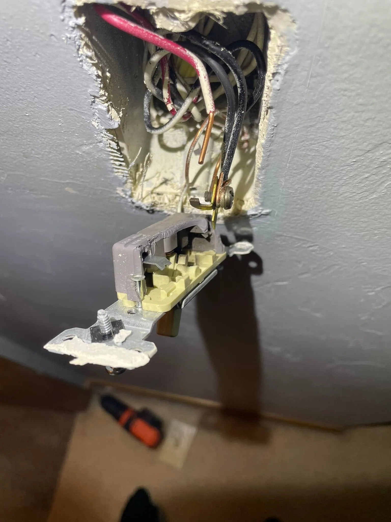 Light switch hanging loose from wall box exposed wires