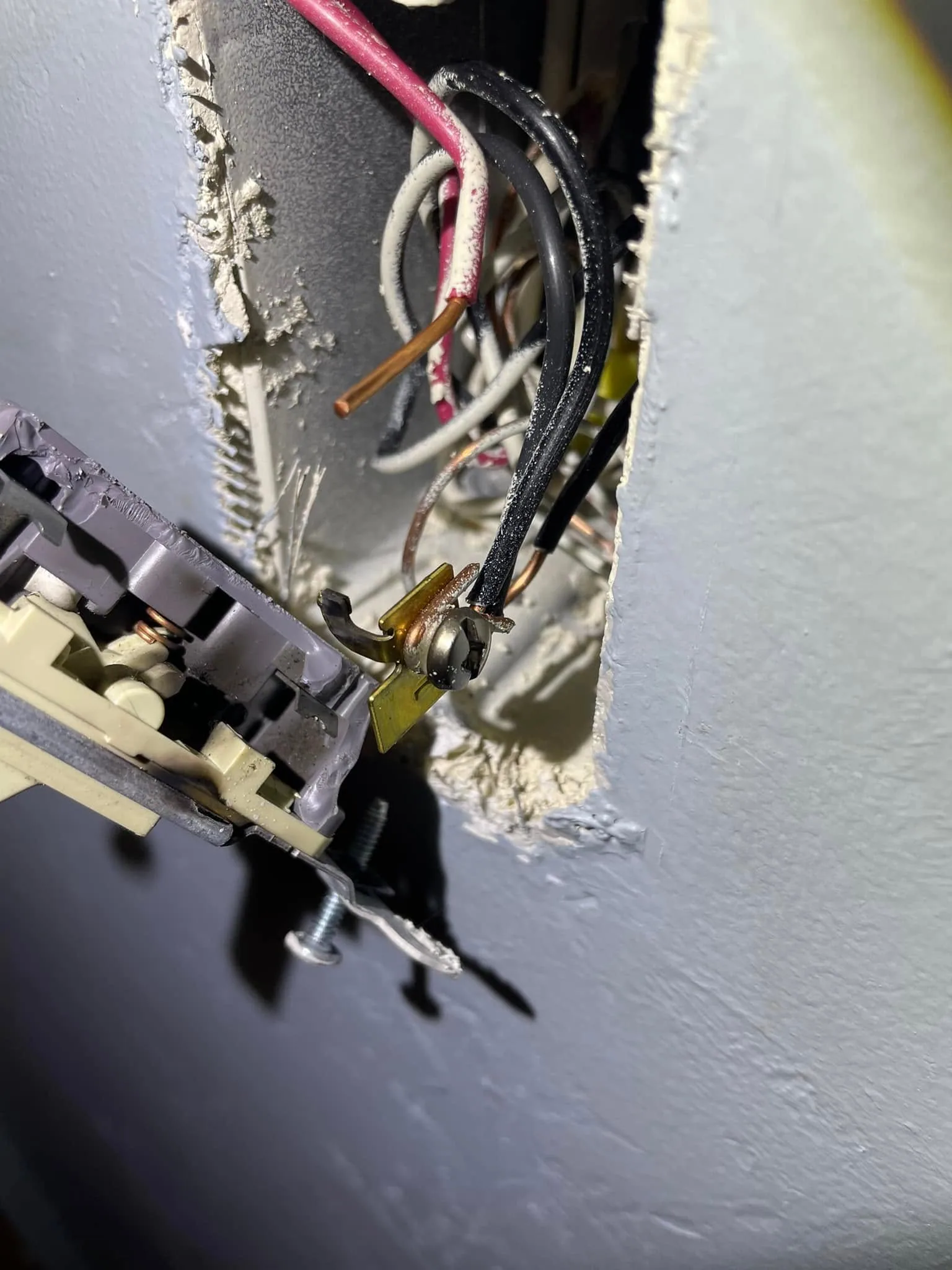 Light switch pulled from wall exposed wires no box
