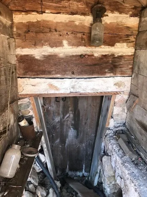 Old cellar door log wall mason jar light stone foundation
