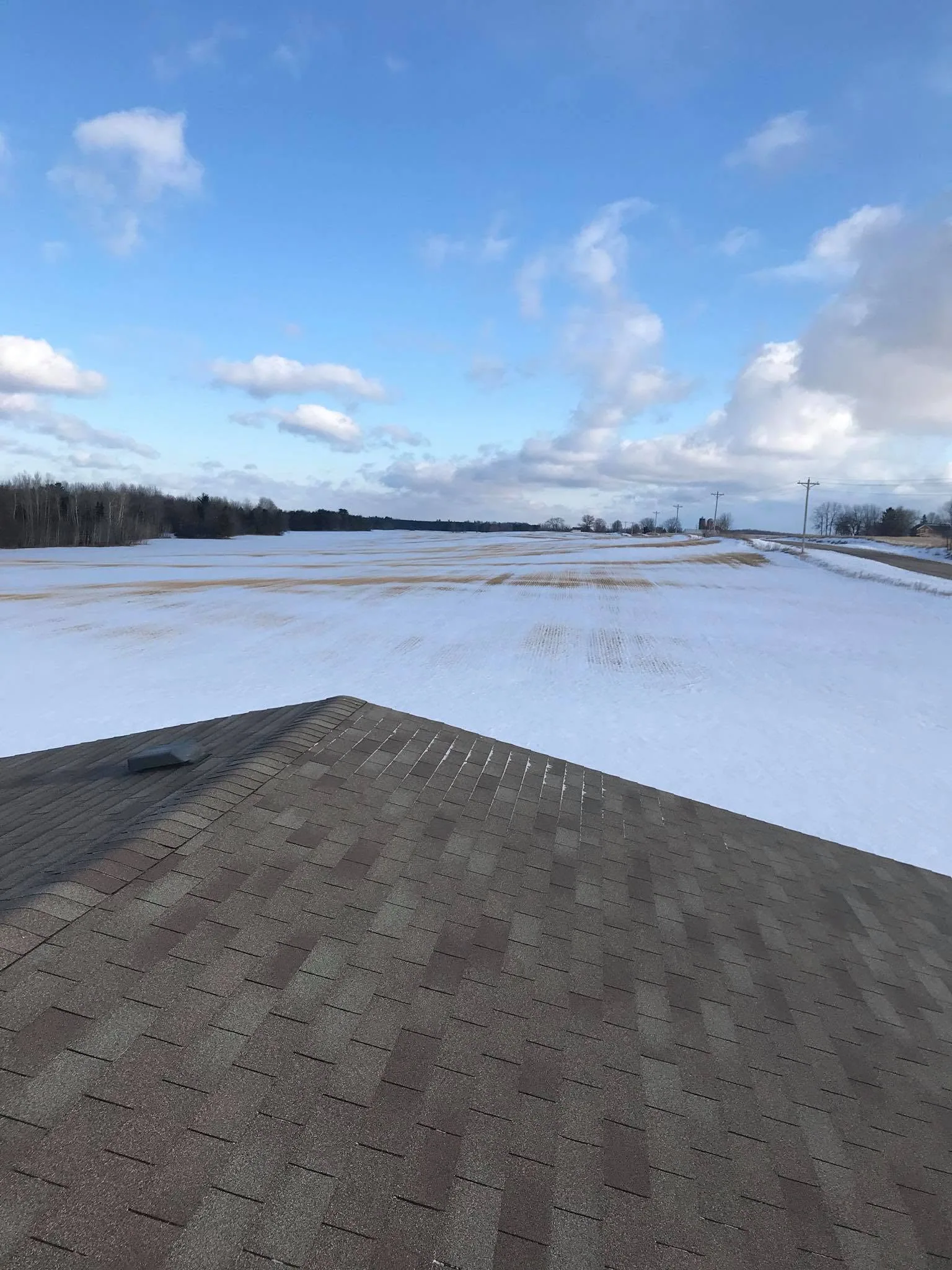 Rooftop shingle inspection winter field
