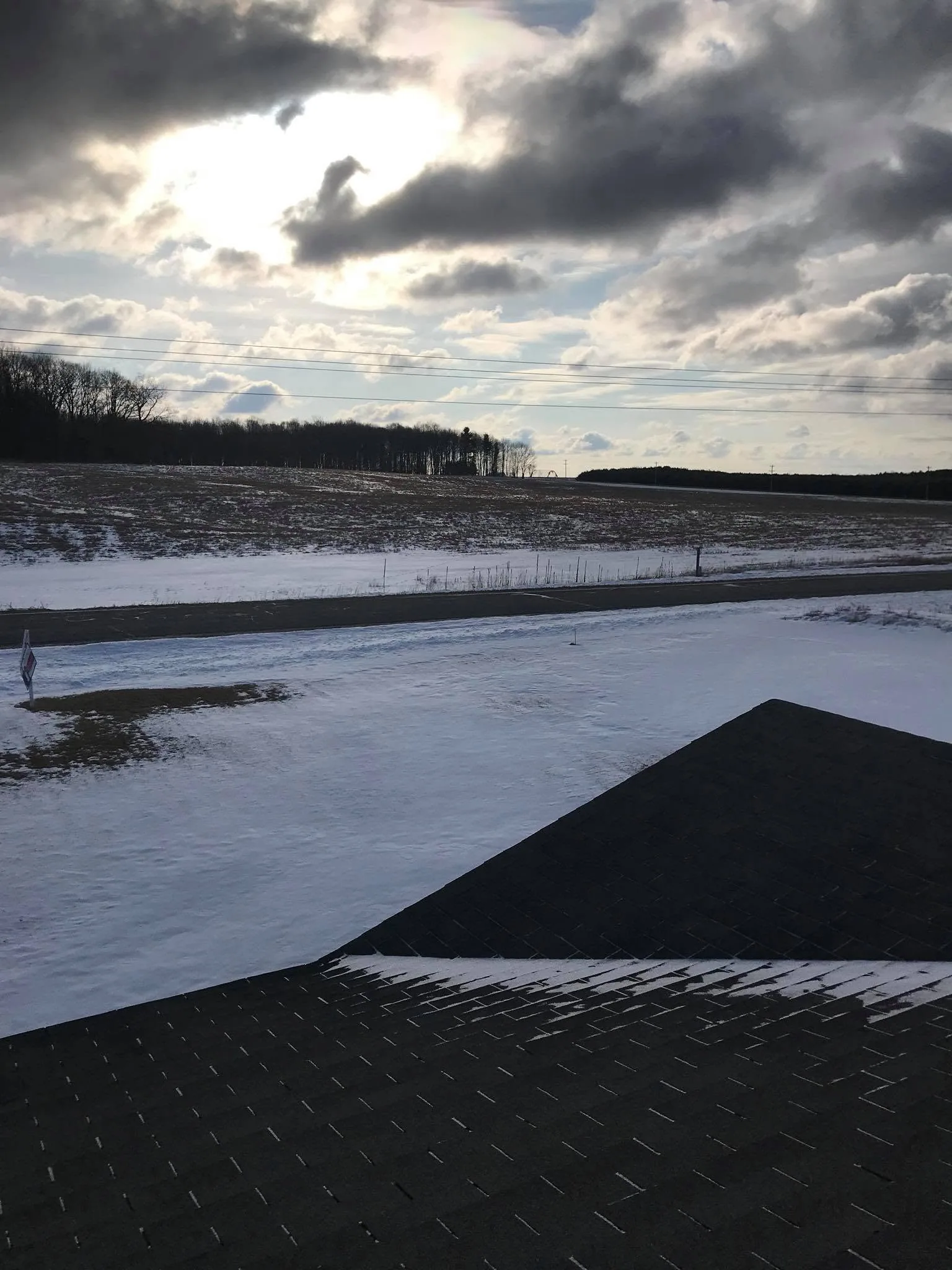 Winter rooftop view asphalt shingles